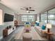 Living room boasts luxury vinyl flooring, a ceiling fan, and large windows at 3545 Landale Dr, Holiday, FL 34691