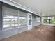 Patio with screened windows and door overlooking backyard and water at 3545 Landale Dr, Holiday, FL 34691