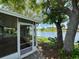 Screened porch with scenic water view and mature trees at 3545 Landale Dr, Holiday, FL 34691