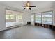 The sunroom features sliding glass doors and windows with views of the adjacent lake and backyard at 3545 Landale Dr, Holiday, FL 34691