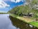 Scenic waterfront home showcasing mature trees and water access at 3545 Landale Dr, Holiday, FL 34691