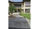 Exterior facade of the condos with palm trees, well-manicured lawn, and numbered address at 4743 Jasper Dr # 107, New Port Richey, FL 34652