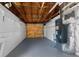 Unfinished basement offering potential for storage or customization with painted floor and exposed ceiling at 5208 Chet Dr, New Port Richey, FL 34652