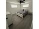 Cozy bedroom with a comfortable bed, ceiling fan, and ample natural light at 5208 Chet Dr, New Port Richey, FL 34652