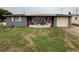Charming single-story home with a cozy front yard and inviting front patio seating area at 5208 Chet Dr, New Port Richey, FL 34652