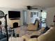 Inviting living room with a brick fireplace, open to the dining area, filled with natural light at 5208 Chet Dr, New Port Richey, FL 34652