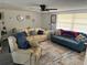 Inviting living room featuring comfortable seating, a ceiling fan, and a large window at 5208 Chet Dr, New Port Richey, FL 34652
