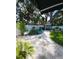 Landscaped backyard featuring crushed stone, a patio with seating, lush landscaping, and a barbecue area at 5710 Broadway Ave, New Port Richey, FL 34652