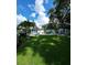 Expansive backyard featuring lush greenery, outdoor seating, a fire pit, and a patio at 5710 Broadway Ave, New Port Richey, FL 34652