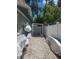 Long driveway with white fence and a carport near the end of the driveway at 5710 Broadway Ave, New Port Richey, FL 34652