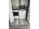 Clean laundry room with a washer and dryer set, cabinets and a decorative rug at 5710 Broadway Ave, New Port Richey, FL 34652