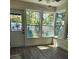 Charming sunroom with hardwood floors, white trim and multiple windows showing the outside at 5710 Broadway Ave, New Port Richey, FL 34652