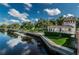 Picturesque canal with clear water, landscaping, and building architecture with a clear blue sky at 5710 Broadway Ave, New Port Richey, FL 34652