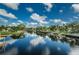 Beautiful canal with clear water, lush trees, manicured lawns and a blue sky with white clouds at 5710 Broadway Ave, New Port Richey, FL 34652