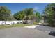 Backyard with a screened-in pool, patio area and a white vinyl fence at 6347 Shadydale Ave, Spring Hill, FL 34609