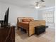 Bedroom with neutral colors, tile floors, ceiling fan and window at 6347 Shadydale Ave, Spring Hill, FL 34609