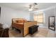 Bedroom with neutral colors, tile floors, ceiling fan and window at 6347 Shadydale Ave, Spring Hill, FL 34609