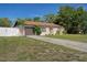 Well-maintained single-story home with a tidy lawn, tidy landscaping, and an attached garage with driveway at 6347 Shadydale Ave, Spring Hill, FL 34609