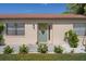 Close-up of the front door highlighting its sunflower wreath, and small manicured landscaping at 6347 Shadydale Ave, Spring Hill, FL 34609