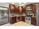 Stylish kitchen with stainless steel appliances, granite counters, and brown cabinets at 6347 Shadydale Ave, Spring Hill, FL 34609