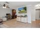 Bright living room with tiled floors, TV, neutral paint, ceiling fan, and dining space at 6347 Shadydale Ave, Spring Hill, FL 34609