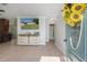Open-concept living room featuring tiled floors, TV, and adjacent dining and bathroom at 6347 Shadydale Ave, Spring Hill, FL 34609