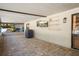 Enclosed patio space with brick flooring, mounted television and access door at 6347 Shadydale Ave, Spring Hill, FL 34609