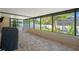 Enclosed patio with brick flooring, grill and a view of the backyard at 6347 Shadydale Ave, Spring Hill, FL 34609