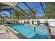 This pristine screened-in pool is lined with brick and boasts a bright blue hue, inviting you for a swim at 6347 Shadydale Ave, Spring Hill, FL 34609