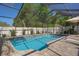 The inviting screened-in pool is surrounded by a spacious patio and landscaped borders for ultimate enjoyment at 6347 Shadydale Ave, Spring Hill, FL 34609