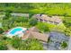 Aerial view of condo complex highlighting pool, clubhouse, and proximity to natural areas at 6462 River Run Blvd, Weeki Wachee, FL 34607