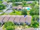 An aerial view of condo buildings with lush green landscaping and a community pool in the background at 6462 River Run Blvd, Weeki Wachee, FL 34607