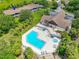 An aerial view of community amenities including a pool, clubhouse and surrounding landscape at 6462 River Run Blvd, Weeki Wachee, FL 34607