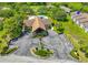 An aerial view featuring condo buildings, a community pool, clubhouse, and lush greenery at 6462 River Run Blvd, Weeki Wachee, FL 34607