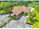 An aerial shot of a clubhouse with palm trees, meticulous landscaping and ample parking space at 6462 River Run Blvd, Weeki Wachee, FL 34607