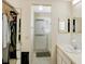 Well-lit bathroom featuring a sink, mirror, and a shower with sliding glass doors at 6462 River Run Blvd, Weeki Wachee, FL 34607