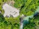 Aerial view of a sandy beach with crystal clear water and lush trees surrounding the shore at 6462 River Run Blvd, Weeki Wachee, FL 34607