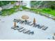 Aerial view of a sandy beach with sun loungers and umbrellas near the water, perfect for relaxation at 6462 River Run Blvd, Weeki Wachee, FL 34607