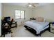 Bright bedroom with a ceiling fan, a large window, and a bed at 6462 River Run Blvd, Weeki Wachee, FL 34607