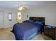Well-lit main bedroom features a large bed, ceiling fan, and ensuite bath, creating a comfortable retreat at 6462 River Run Blvd, Weeki Wachee, FL 34607
