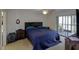 Bright bedroom boasts a large bed, ceiling fan, and access to the balcony, perfect for relaxation at 6462 River Run Blvd, Weeki Wachee, FL 34607
