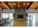 The community room is bright with natural light, a wood ceiling, stone fireplace, and direct access to outdoor activities at 6462 River Run Blvd, Weeki Wachee, FL 34607