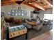 Community game room boasts a vaulted wood ceiling, foosball table, and multiple seating areas for relaxing with friends at 6462 River Run Blvd, Weeki Wachee, FL 34607