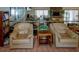 Cozy interior with comfortable armchairs, a bookcase, a fireplace and tile flooring at 6462 River Run Blvd, Weeki Wachee, FL 34607