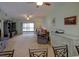 Spacious living room featuring a high ceiling, ceiling fans, and sliding glass doors to the balcony at 6462 River Run Blvd, Weeki Wachee, FL 34607