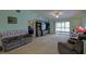 Spacious living room features plush seating, a large entertainment center, and sliding glass doors to the lanai at 6462 River Run Blvd, Weeki Wachee, FL 34607