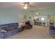 Open-concept living room with ceiling fans and a view of the breakfast bar and kitchen area at 6462 River Run Blvd, Weeki Wachee, FL 34607
