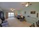 Open living room featuring multiple ceiling fans, sliding glass doors, and plush seating at 6462 River Run Blvd, Weeki Wachee, FL 34607