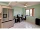 Bright office area featuring tile flooring, window, and modern stainless steel refrigerator at 6462 River Run Blvd, Weeki Wachee, FL 34607