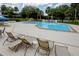 Enjoy a refreshing swim in this well-maintained community pool, surrounded by lounge chairs and lush landscaping at 6462 River Run Blvd, Weeki Wachee, FL 34607